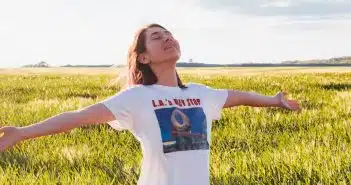 woman standing in green field