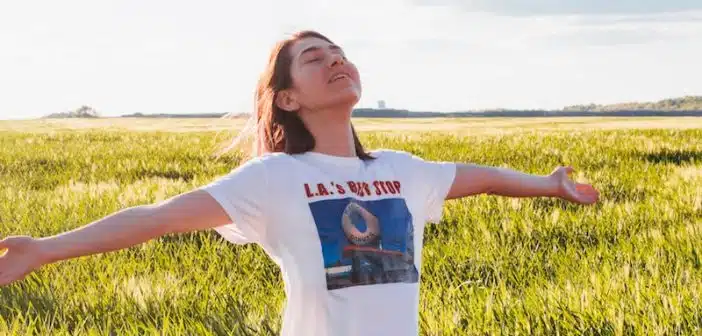 woman standing in green field